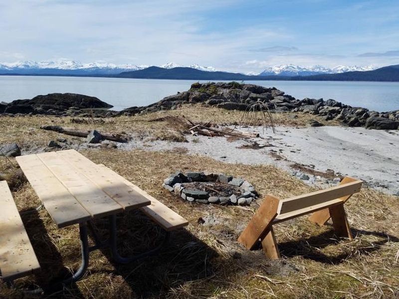 Picnic table and fire ring on sand beach