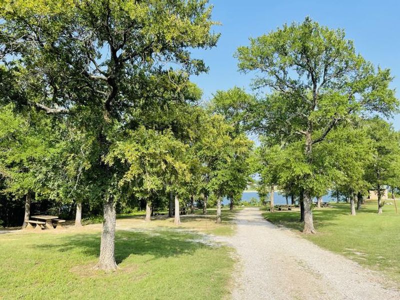 A photo of facility CANEY CREEK with Picnic Table, Fire Pit, Shade, Water Hookup