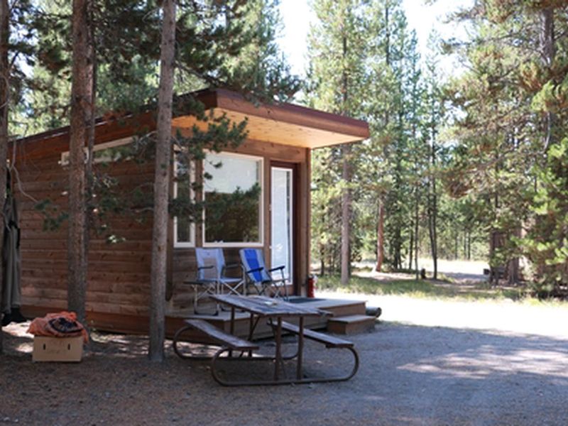 Headwaters Camper Cabins are scattered throughout the campground and include double-double or double-single bunk-style beds. While the bunks are padded, bedding and pillows not included. Guests are encouraged to bring their own linens.