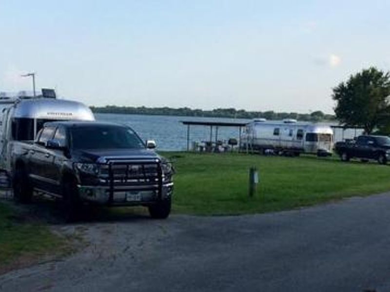 Airstream trailers on RV sites by the lake