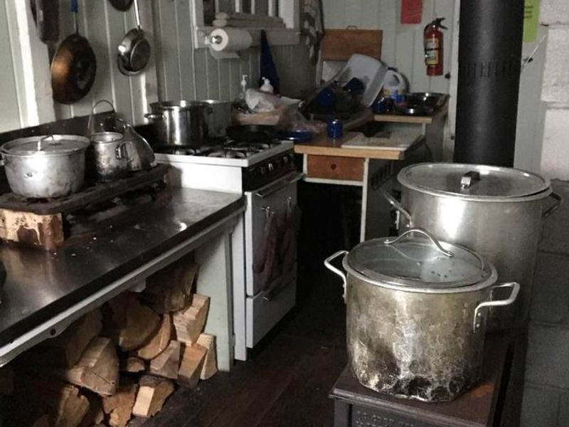 Kitchen with propane stove, oven and wood burning stove