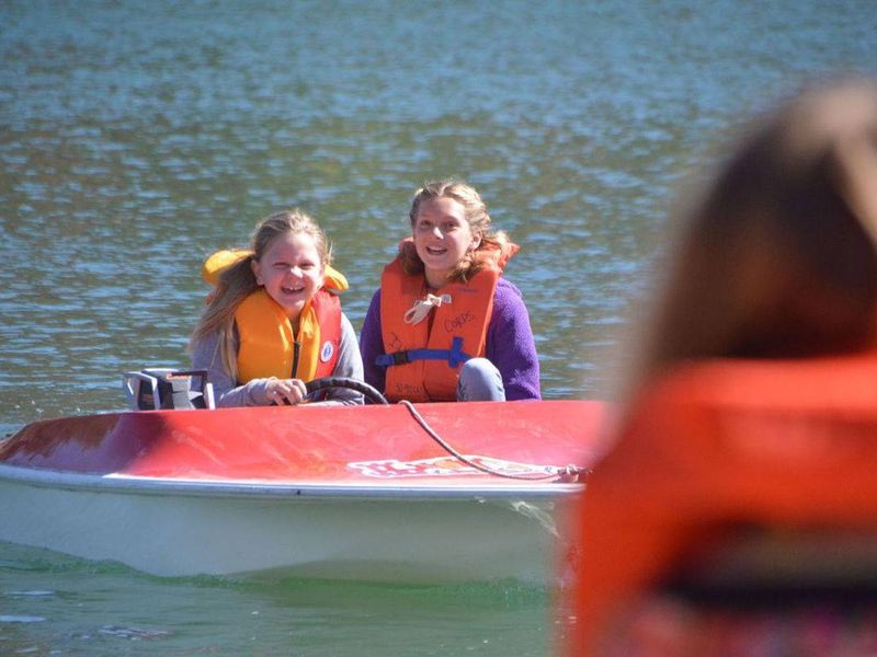 Kid's learning how to operate a motor boat along with water safety