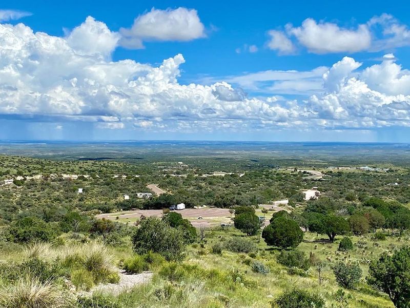 View of Pine Springs Campground as seen from the Guadalupe Peak trail with views of the Permian Basin in the distance.