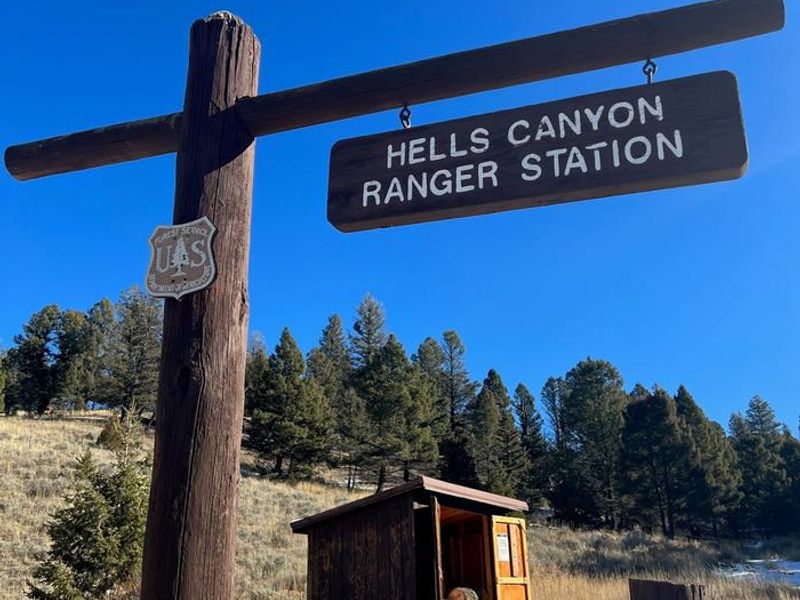 Hells Canyon Ranger Station Sign with woodshed in background