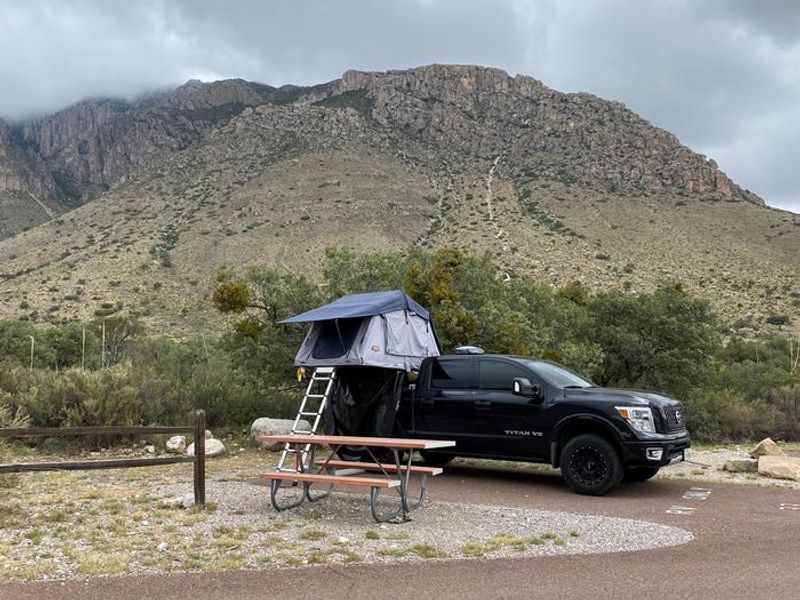 RV campsite in Pine Springs campground. Hunter Peak with rain clouds as a backdrop.
