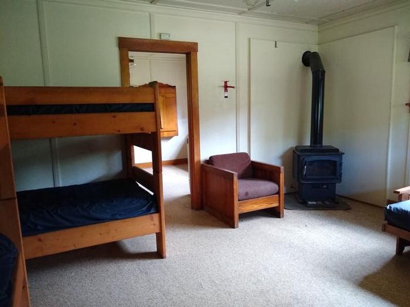 The sleeping room features a wood stove for warmth.