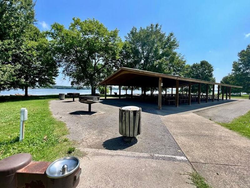 Water Fountain, Electrical Hookup, Trashcans, Grills, and Sidewalk are Located Adjacent to Picnic Shelter
