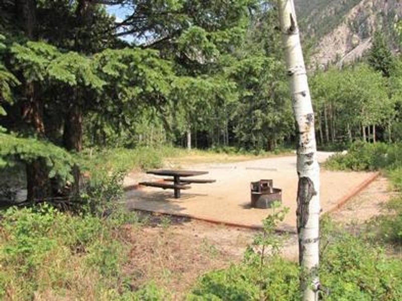 Photo of campsite with fire pit and picnic table