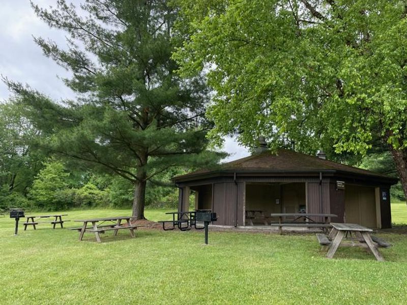 Clark Shelter with multiple picnic tables, two grills, and a bathroom attached to shelter.