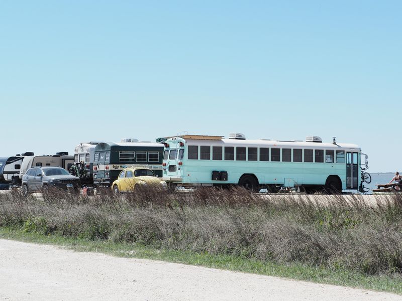 Converted school buses are parked at Bird Island Basin Campgound.