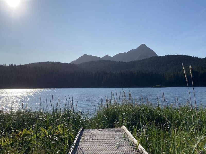 View of Red peak over trees from boardwalk of Blue Fox Bay public use cabin