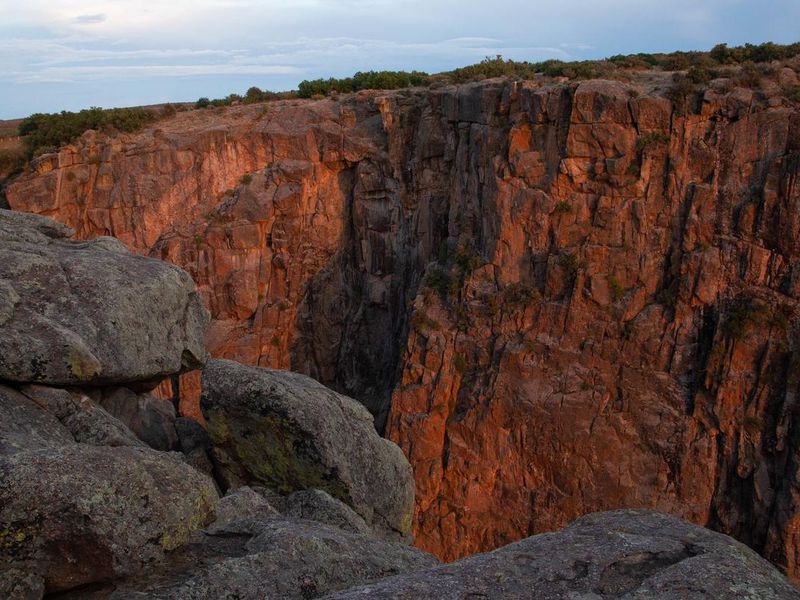 Sunlit Black Canyon of the Gunnison cliff face as seen from the South Rim 