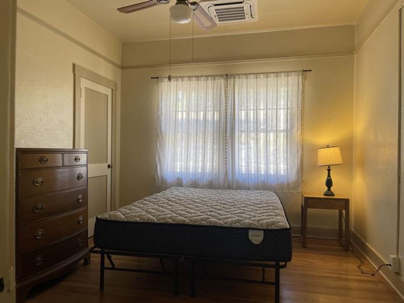 Bedroom with bed, dresser, and lamp