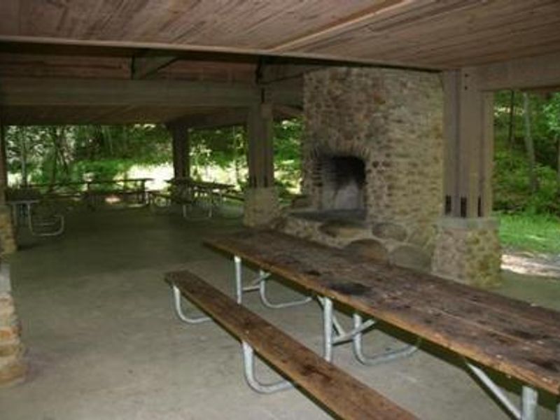 Picnic tables in pavilion and view of fireplace