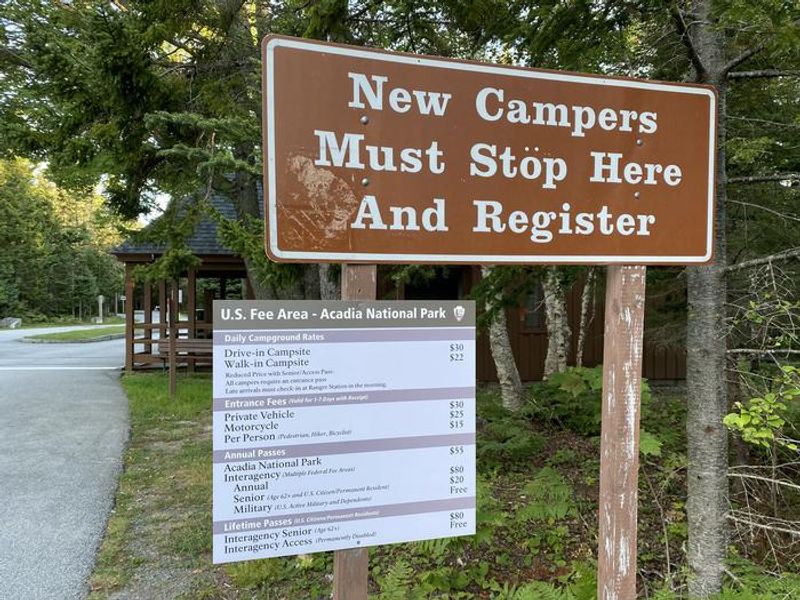 Signs for new camper information and park pass description.