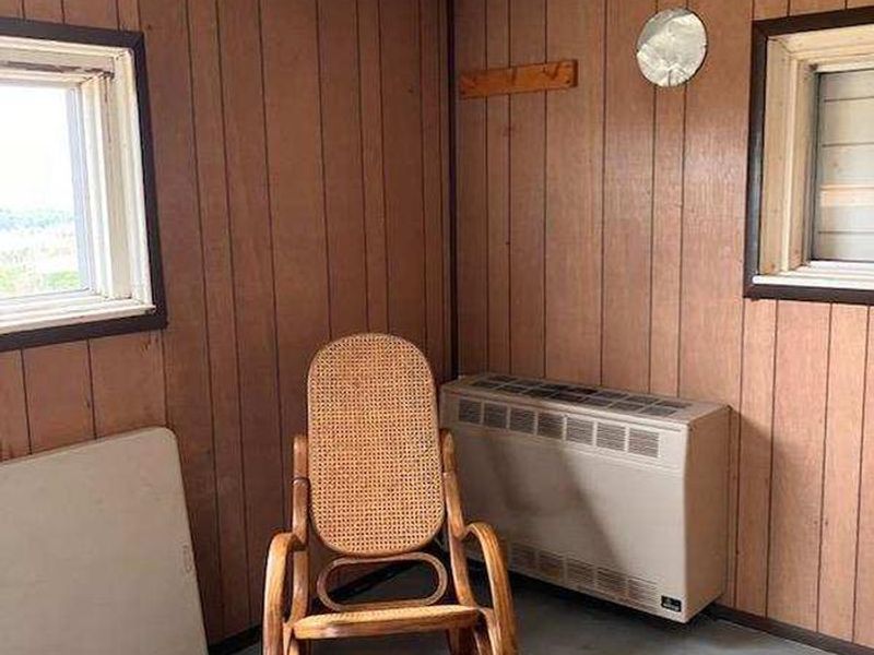 Looking inside bedroom of the lookout. Propane heat stove replaced June 2023.