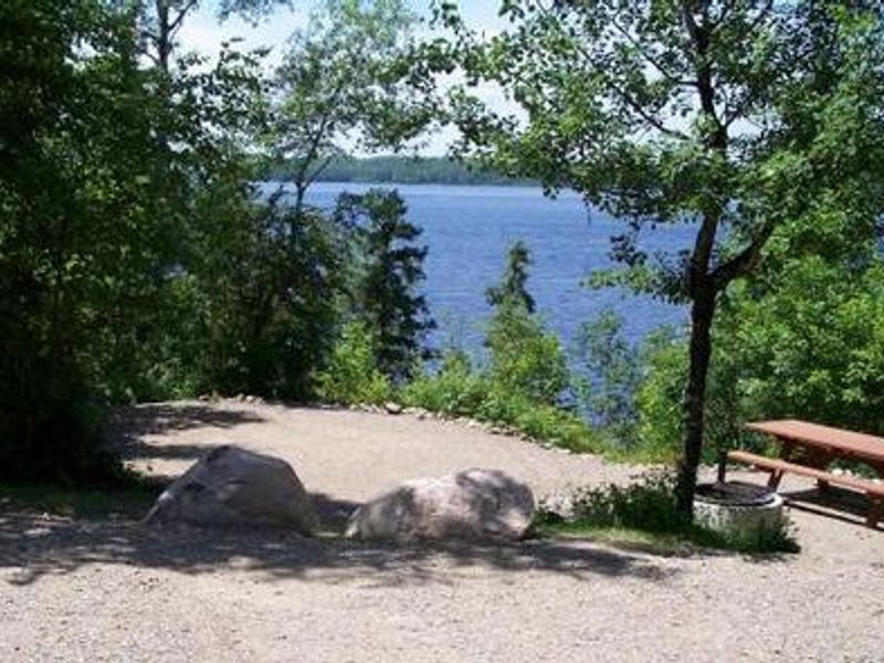 Typical campsite on the edge of Fall Lake.  Campsite facilities including tent pads, tables, and firegrates may be accessed via level trails or steps, depending on location of campsite.