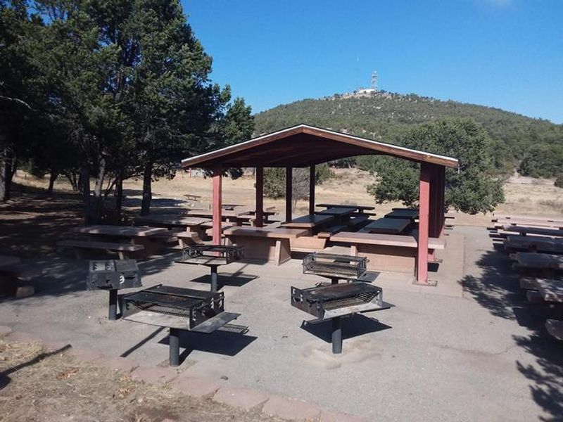 Cedro Peak Robin Campsite Pavilion with multiple picnic tables and grills