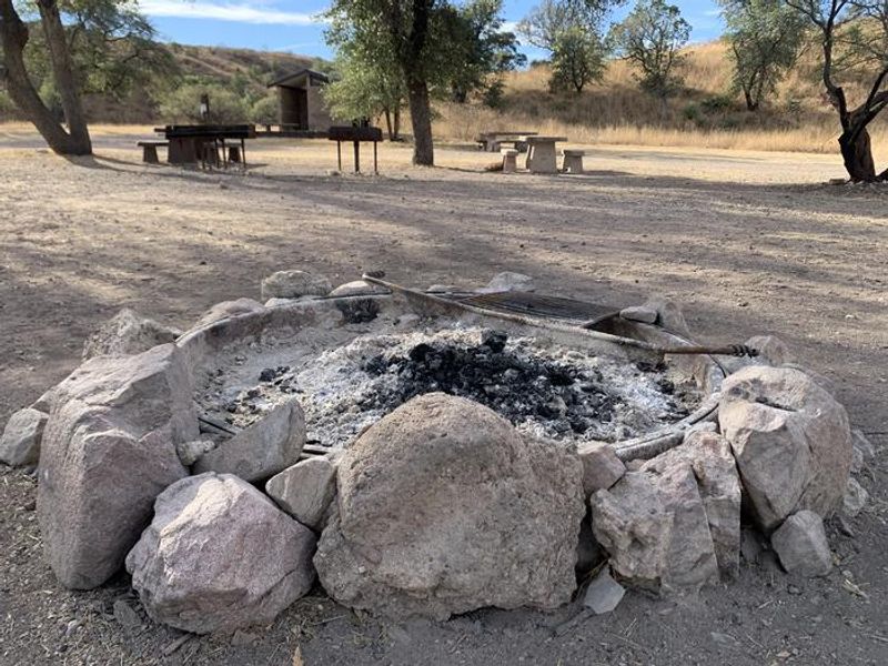 Stone-ringed fire pit in the central area of the campground.