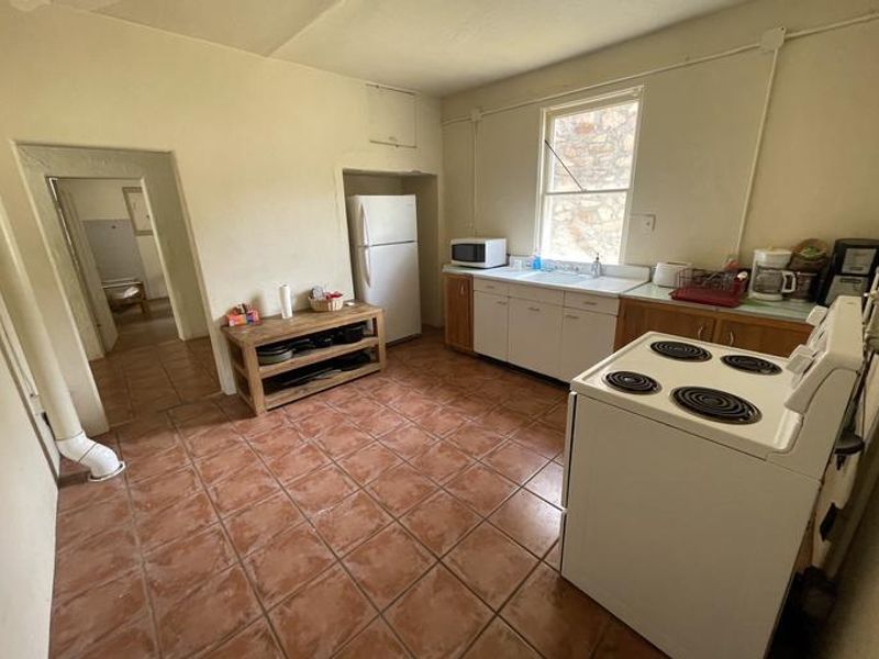 Kitchen of Shaw House. Outfitted with stove/oven, fridge, microwave, coffee maker, and other supplies.
