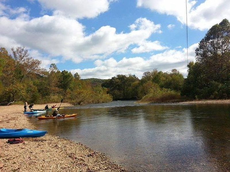 Kayaks on the water and beach at Pulltite