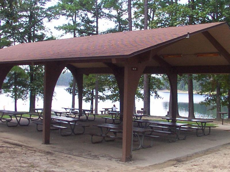 Pavilion with electricity, tables, grills, and short walking distance to swim beach.