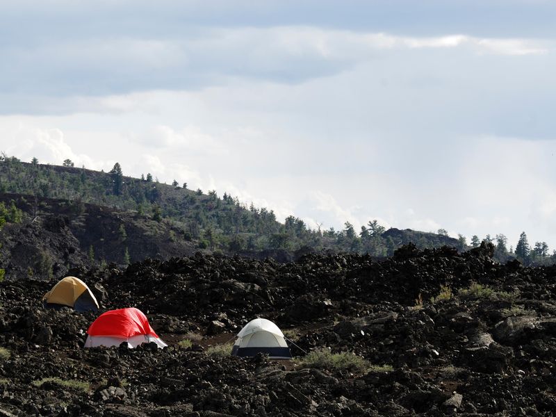 The Lava Flow Campground offers 42 sites nestled among the black lava rocks between the visitor center and North Crater.