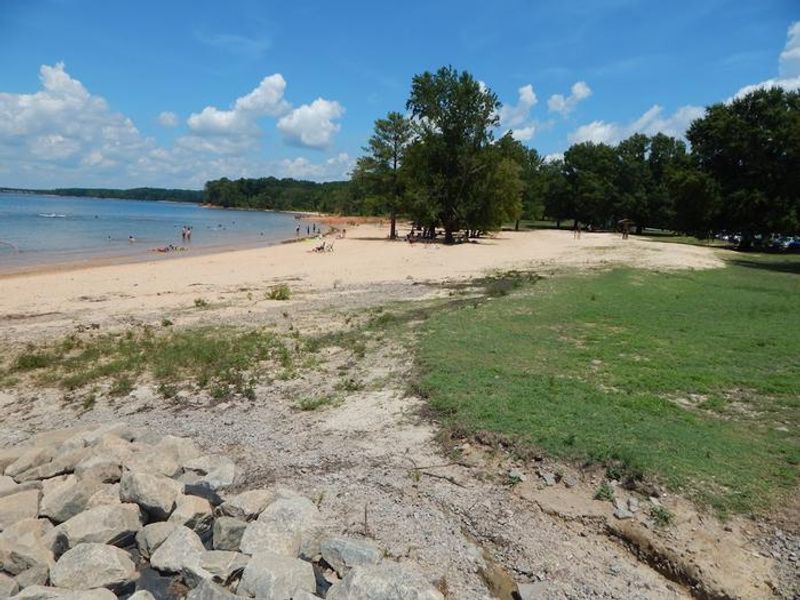 This is a photo of the designated swimming area at Palmer Point. There is a nice sandy beach with trees for shade. 