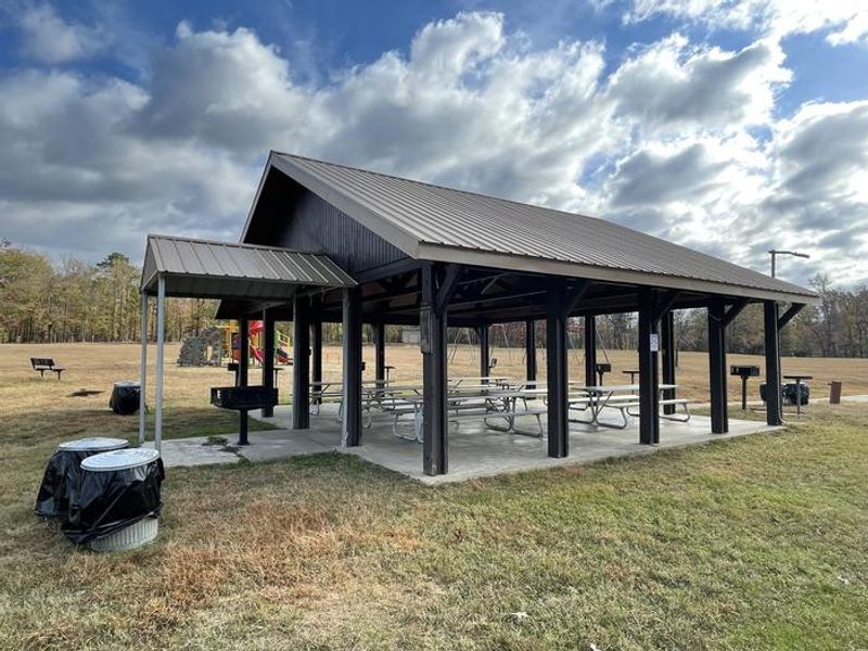 Pavilion with electricity, water, grills, tables, and playground. 