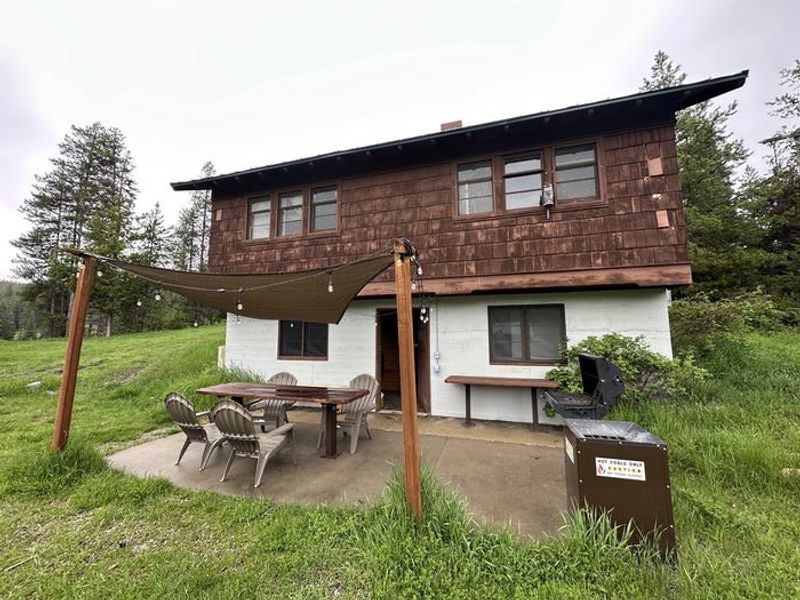 Star Meadow Guard Station back side of cabin view with patio.
