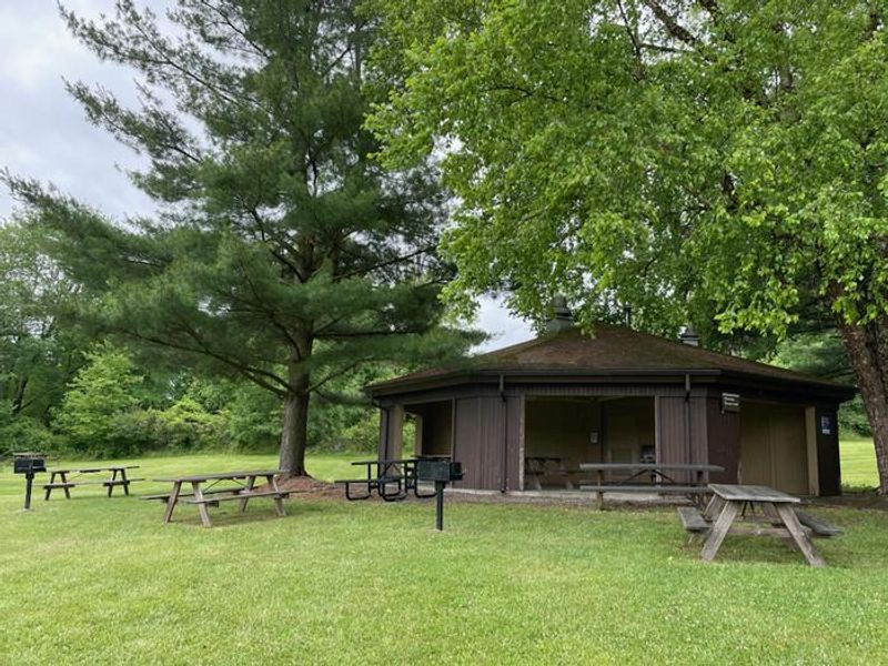 Clark Shelter with multiple picnic tables, two grills, and a bathroom attached to shelter.