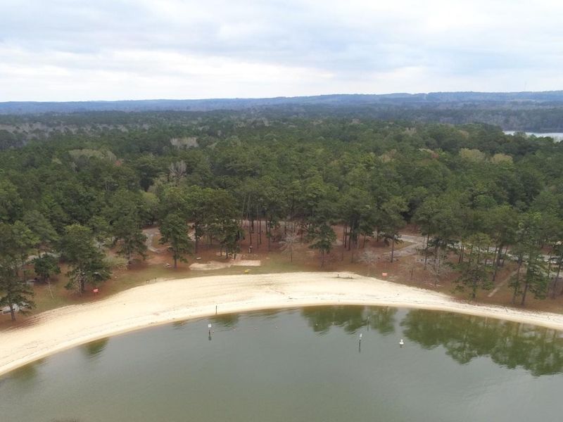 Aerial view of Cottonhill Campground overlooking swim beach in foreground and campsites in back ground. 