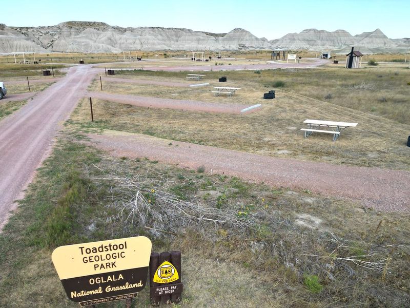 Entrance into the Toadstool Campground with badlands in the background.