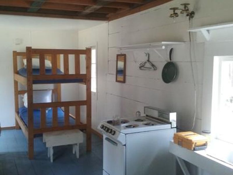 Bunk, sink and stove in the small 12'x24' cabin.