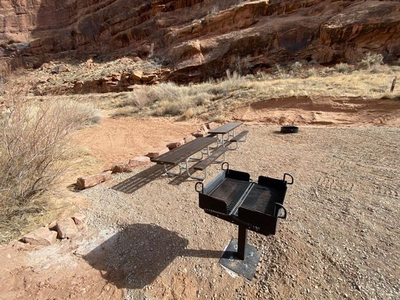 Group campsite picnic tables, fire pit, and grill.