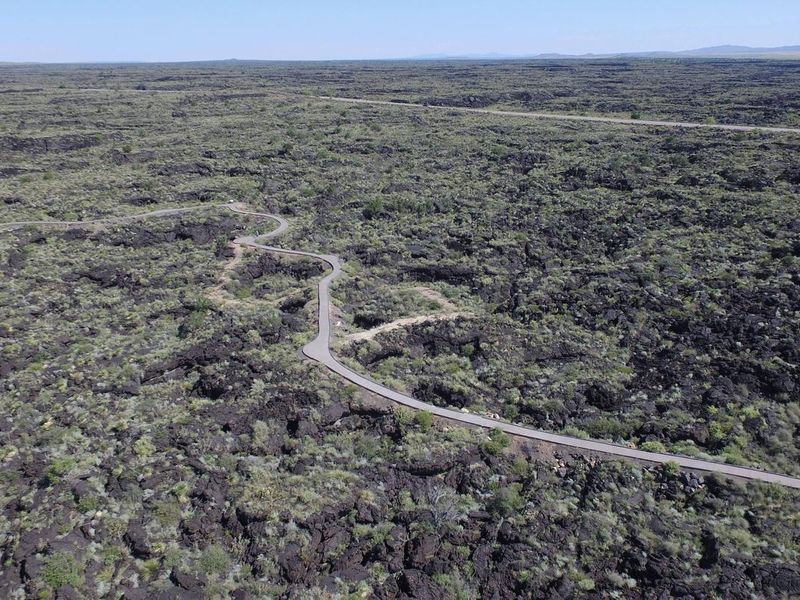 Looking west over the lava with the Malpais Nature Trail and highway 380 in the background.