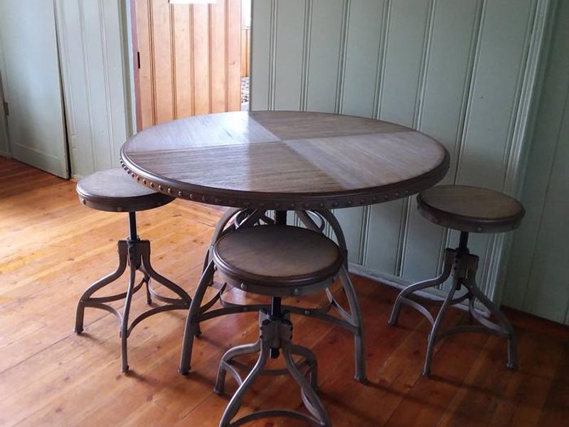 Stylish table and bar stools accent the dining area in the cabin.