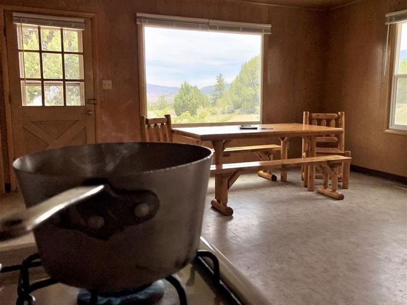 A boiling pot sits on the gas stove in the kitchen of Orange Olsen Dwelling.