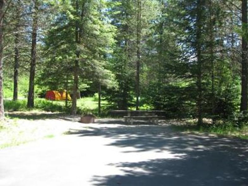 Tent, picnic table and fire ring. 