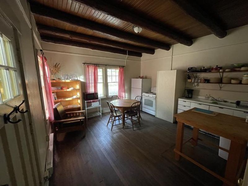 Kitchen and Dining Room of Portal Bunkhouse, outfitted with Fridge, stove/oven, microwave, and coffeemaker.