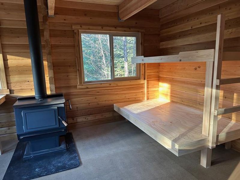 Downstair bunks next to wood stove. 