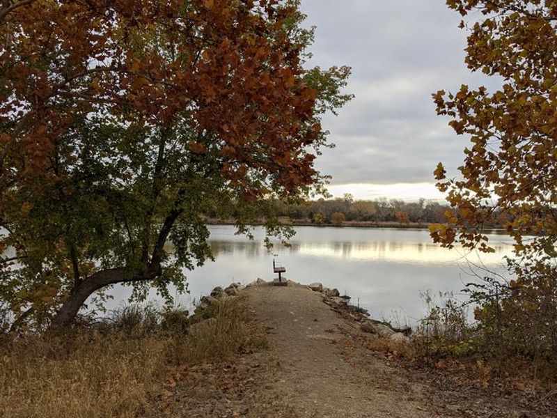 Fall colors surround a quiet fishing spot at the gathering pond