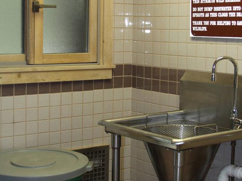 Sink where campers pour dirty water from a container after washing dishes at campsite. (This is NOT a dishwashing station).