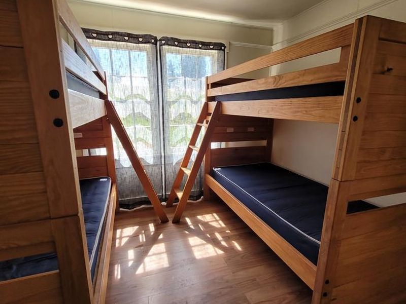 The downstairs bedroom features two bunk beds