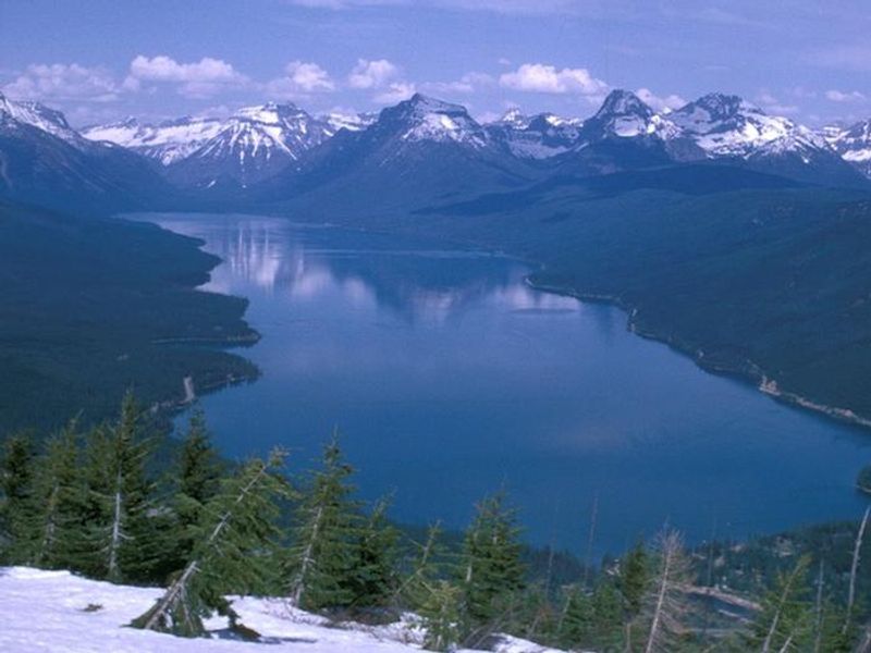Lake McDonald surrounded by snow covered peaks.