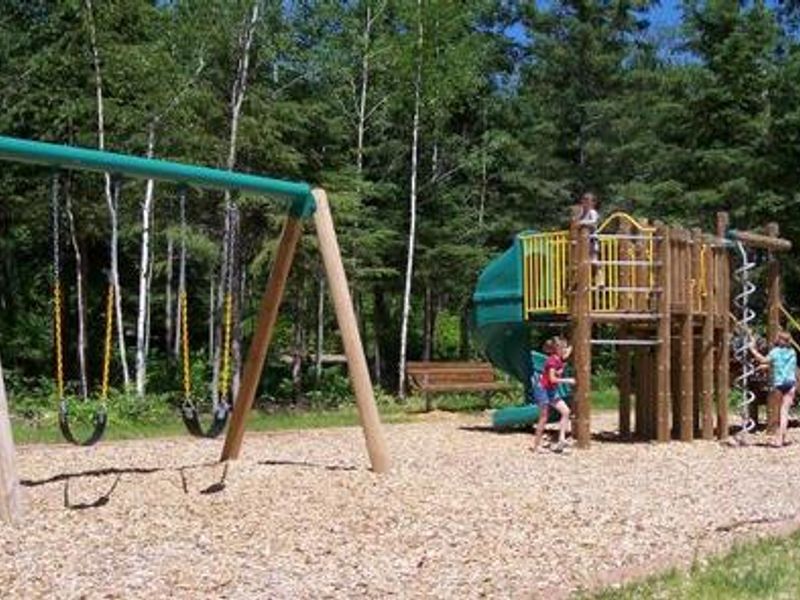 Play area next to the beach and picnic area.  Play area contains swings, slide, and climbing features.