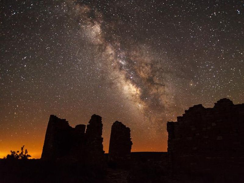 Ancient structures silhouetted against the night sky and the Milky Way. Hovenweep trails close at sunset. Night photography off the paved sidewalk requires a special use permit issued by the superintendent.