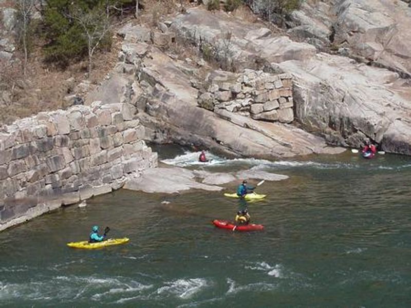 Kayakers by old mining company dam on St. Francis river