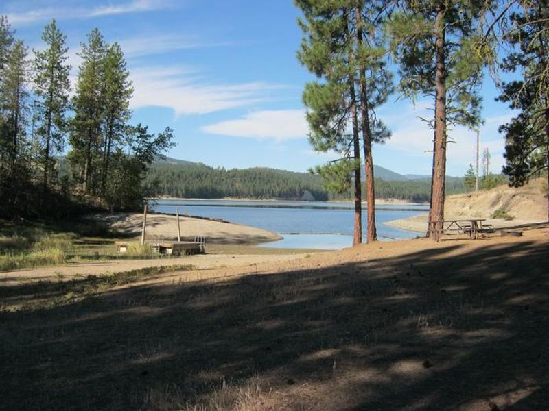 Cloverleaf Campground. Trees and lake in the background.