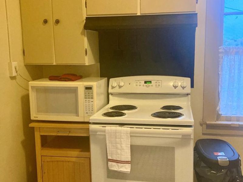 Kitchen with stove and microwave